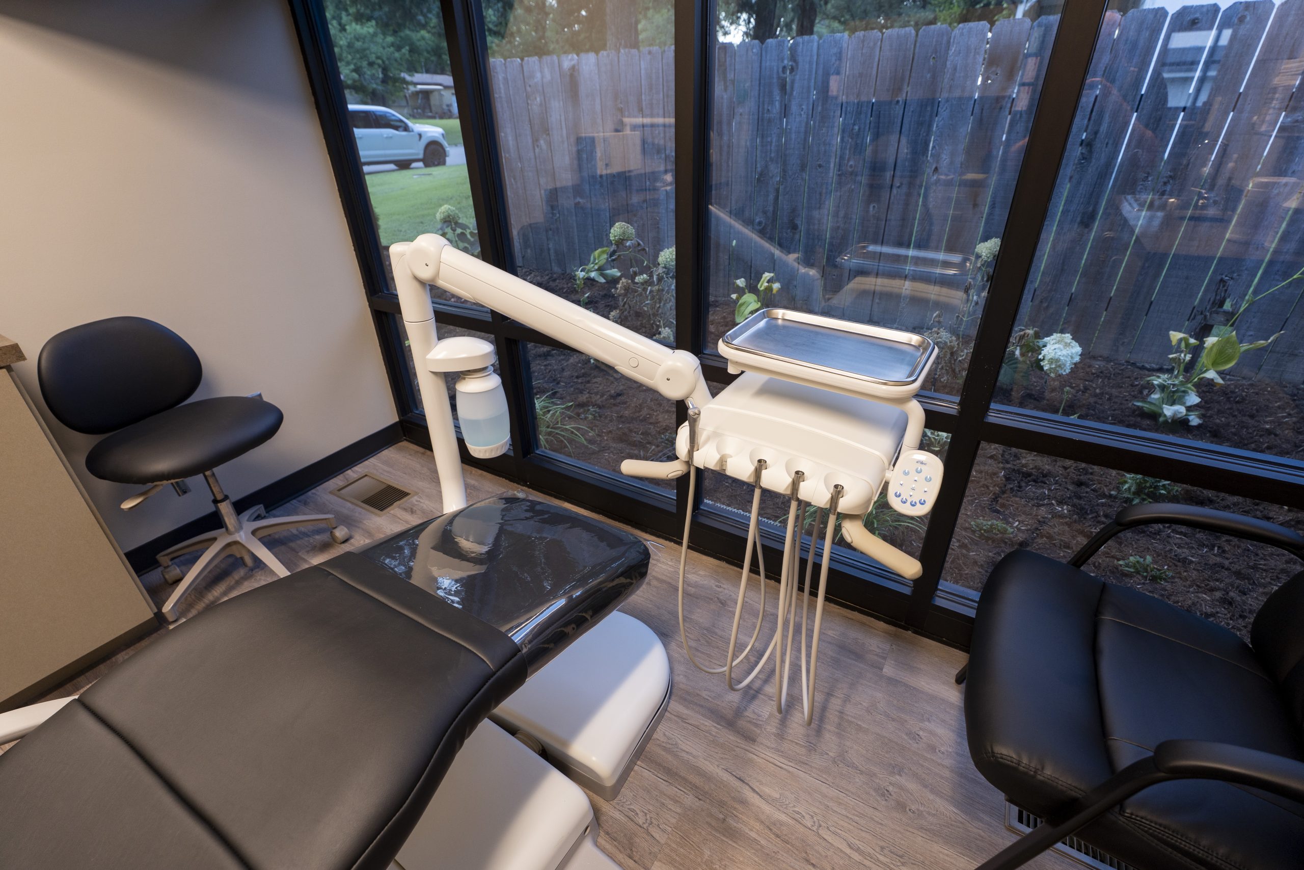 Happy Female Patient Relaxing During Dental Visit – Dentist El Dorado KS Dental chair and technology for appointment – Dentist El Dorado KS